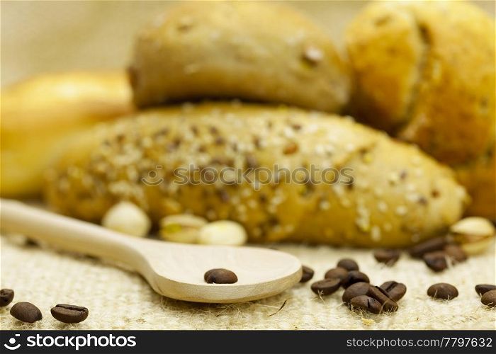 bread , coffee and flour in a spoon on a wicker mat