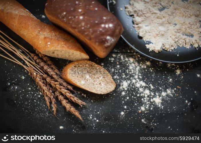 Bread composition with wheats. Bread composition with wheats. Very shallow DOF photo and specific art curly bokeh for extra volume.