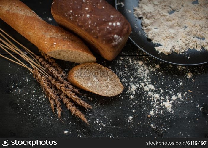 Bread composition with wheats. Bread composition with wheats. Very shallow DOF photo and specific art curly bokeh for extra volume.