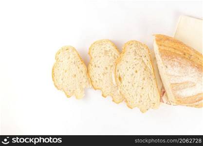 bread concept a few slices of bread and a half loaf of bread on the white background.