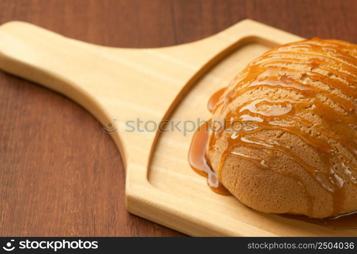 bread drizzled with honey on wooden board closeup. bread on a wooden board