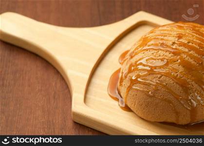 bread drizzled with honey on wooden board closeup. bread on a wooden board