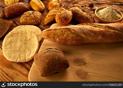 Bread fresh varied mix on golden rustic wood golden table