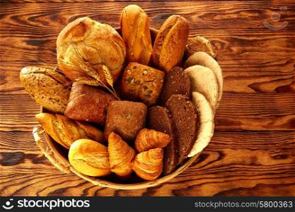 Bread fresh varied mix on golden rustic wood in basket