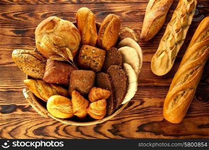 Bread fresh varied mix on golden rustic wood in basket