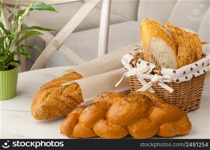 bread in a wicker basket on a light background on a table. bread in a wicker basket