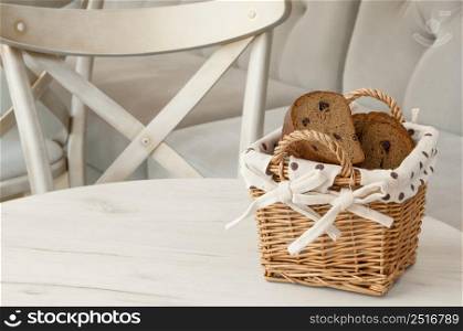 bread in a wicker basket on a light background on a table. bread in a wicker basket