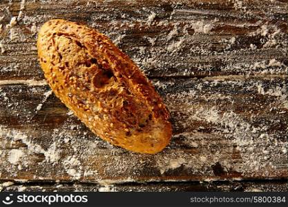 Bread loaf in a rustic wood and wheat flour aerial view