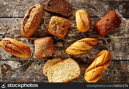 Bread loaf mixed in a rustic wood and wheat flour aerial view