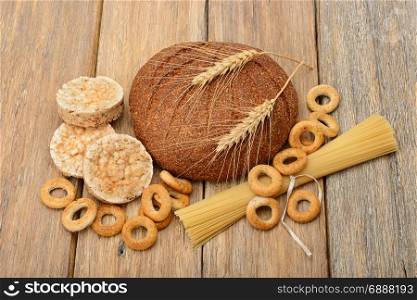 bread, pasta and pastries on a wooden background