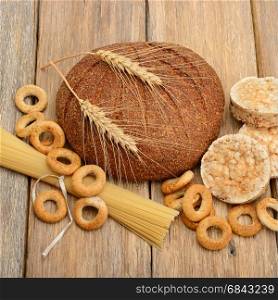 bread, pasta and pastries on a wooden surface