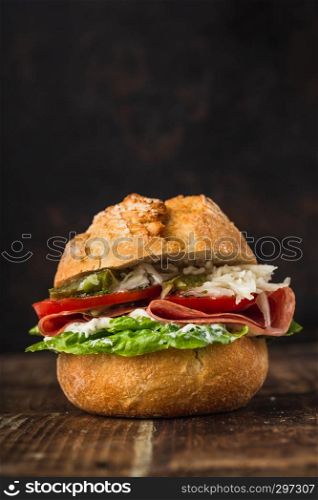 bread rolls topped with salami, salad, tomatoes, coleslaw and remoulade sauce