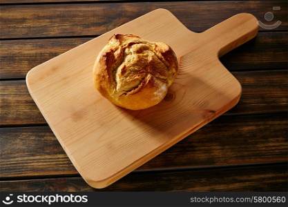 Bread round loaf on wooden board in rustic wood table