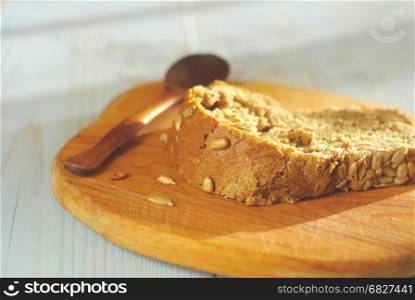 Bread slice organic natural food homemade wholegrain healthy nutrition. Rustical bread on wooden desk oldstyle eating. Tasty baker meal closeup. Selective focus crust piece.