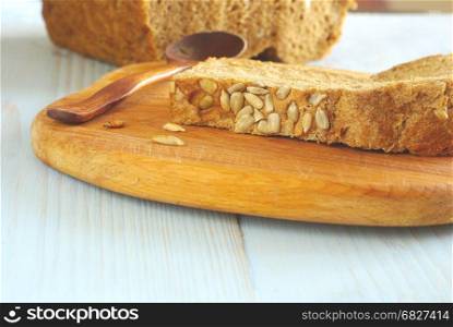 Bread slice organic natural homemade wholegrain healthy nutrition. Healthy dieting food ingredient. Selective focus crust piece. Rustical bread oldstyle eating. Tasty baker meal closeup.