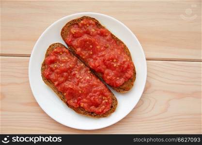 Bread toasted slices with grated tomato Catalonia style pan tomaquet