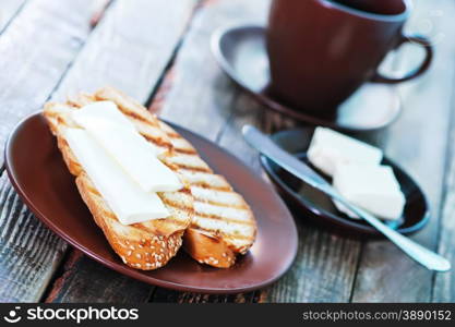 bread with butter and fresh coffee in cup