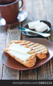 bread with butter and fresh coffee in cup