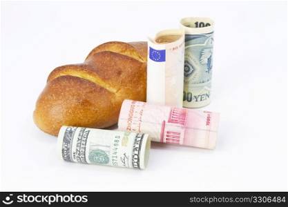 Bread with multiple currencies, dollar, yuan, euro, and yen, depicts a basic, shared commerce and economic interdepency.