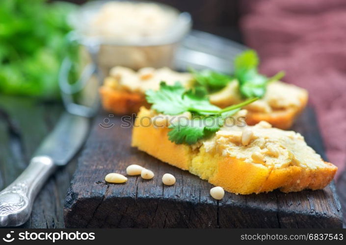 bread with pate on the wooden board