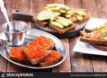 bread with red salmon on a table