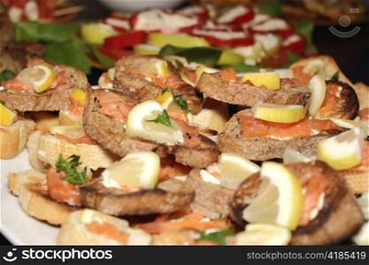 bread with salmon and lemon pieces on top