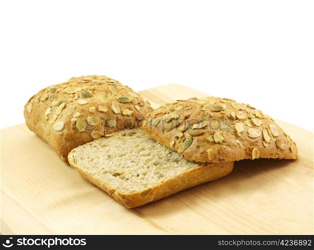 Bread with seeds isolated on a wooden board