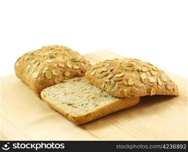 Bread with seeds isolated on a wooden board