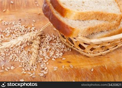 Bread with wheat and ears on plate
