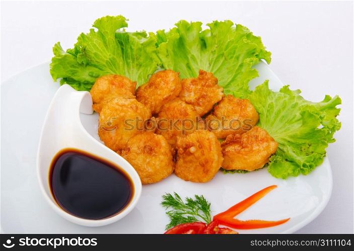 Breaded chicken pieces served with sauce
