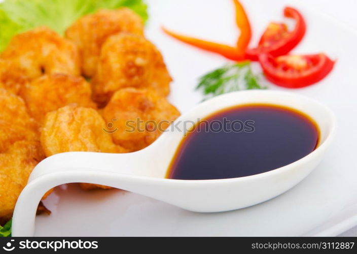 Breaded chicken pieces served with sauce