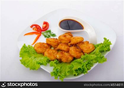 Breaded chicken pieces served with sauce