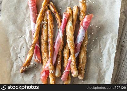 Breadsticks wrapped in jamon