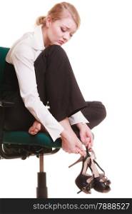 Break from work. Tired businesswoman with leg pain. Young woman massaging her feet on chair isolated on white.