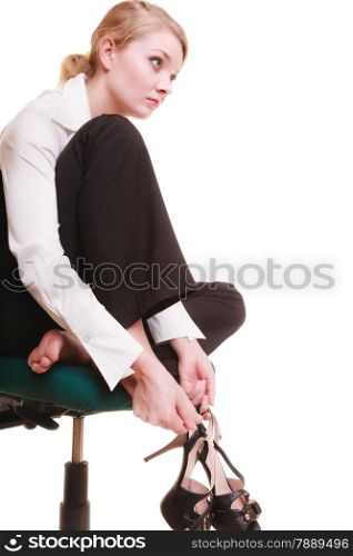 Break from work. Tired businesswoman with leg pain. Young woman massaging her feet on chair isolated on white.