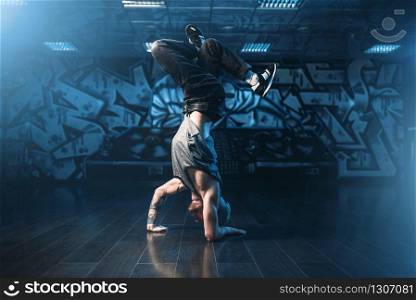 Breakdance motions, performer in dance studio. Modern urban dancing style. Breakdance motions, performer in dance studio