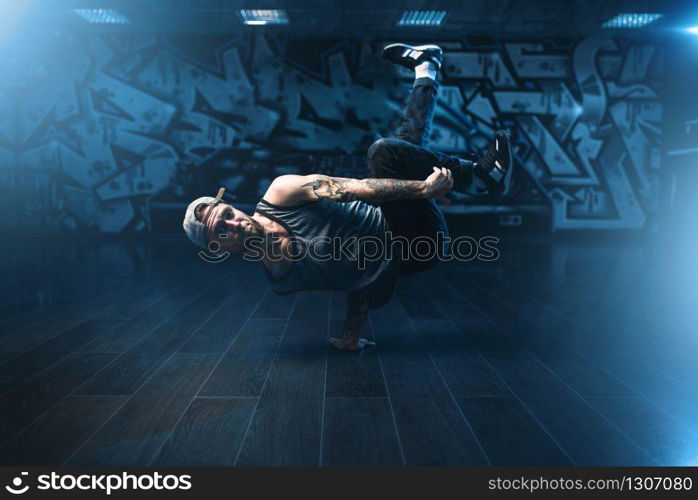 Breakdance performer posing in dance studio. Modern urban dancing style. Breakdance performer posing in dance studio