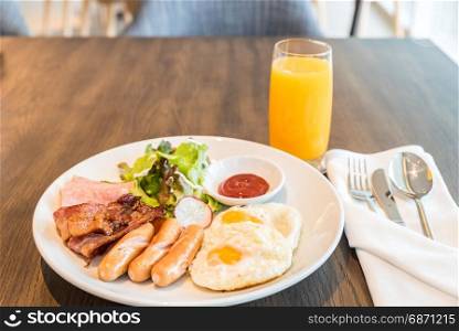 Breakfast Bacon and ham set with fried egg and orange juice