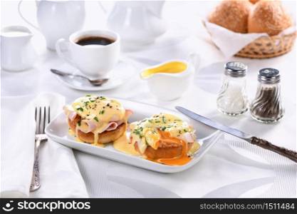 Breakfast. Best Eggs Benedict - fried English bun, ham, poached eggs and delicious Hollandaise butter sauce