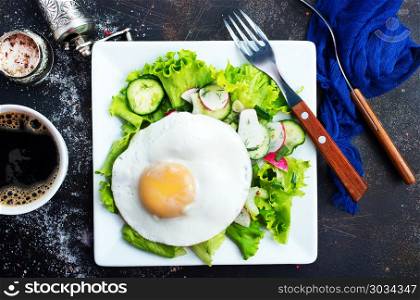 breakfast. breakfast on plate, fried eggs and fresh salad