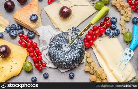 Breakfast cheese plate with various berries, top view