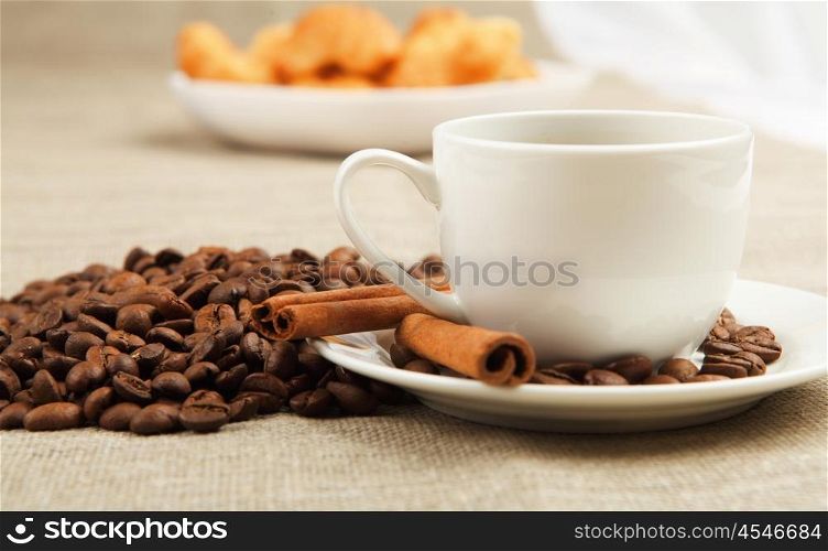 Breakfast coffee and croissants on a table on a light background.