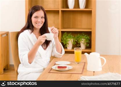 Breakfast coffee and toast happy woman in home bathrobe