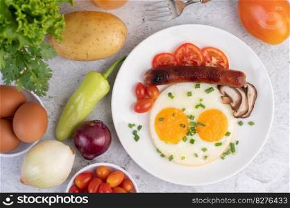 Breakfast consisting of bread, fried eggs, tomatoes, Chinese sausage and mushrooms