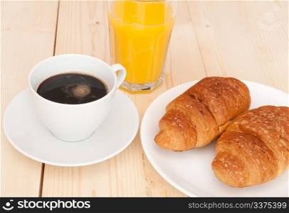 Breakfast - Croissants, Coffee and Orange Juice on Wooden Table