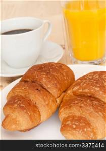 Breakfast - Croissants, Coffee and Orange Juice on Wooden Table