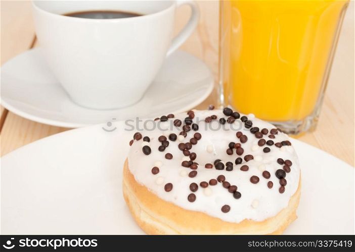 Breakfast - Donut, Coffee and Orange Juice on Wooden Table
