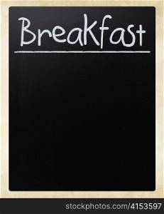 ""Breakfast" handwritten with white chalk on a blackboard"