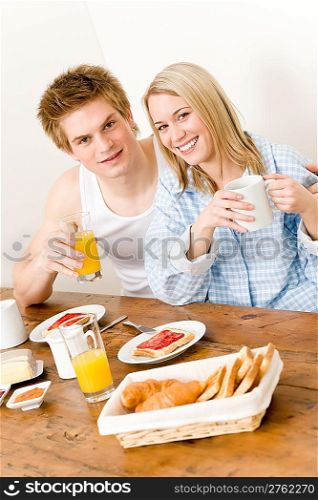 Breakfast happy couple enjoy romantic morning in kitchen