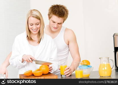 Breakfast happy couple make orange juice in morning kitchen